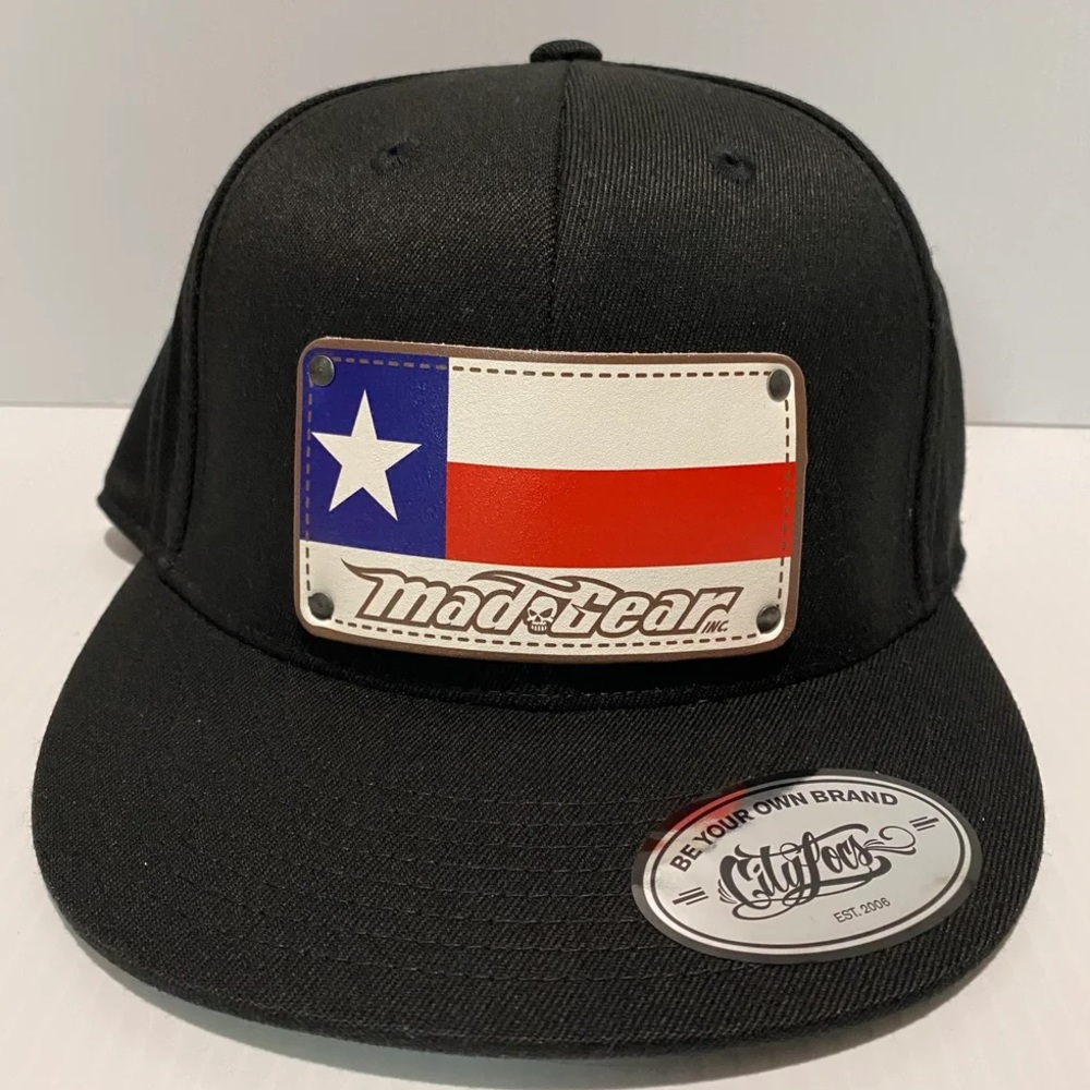 Fitted by FlexFit with flag design by MAD GEAR.